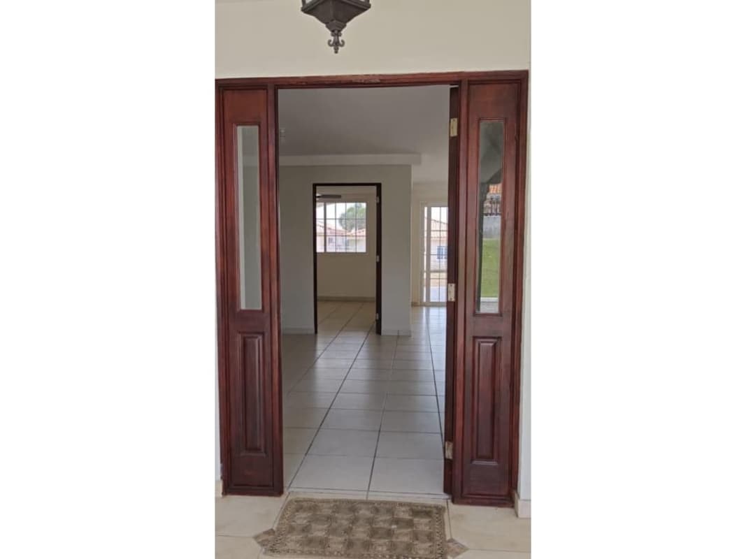 Living room space with tile flooring and visible staircase in Brisas del Golf Panama