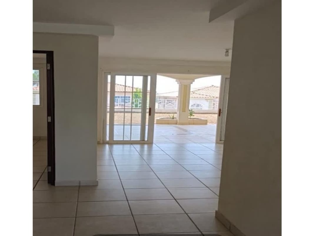 Dining room with sliding glass doors to patio in house at Brisas del Pacifico Panama