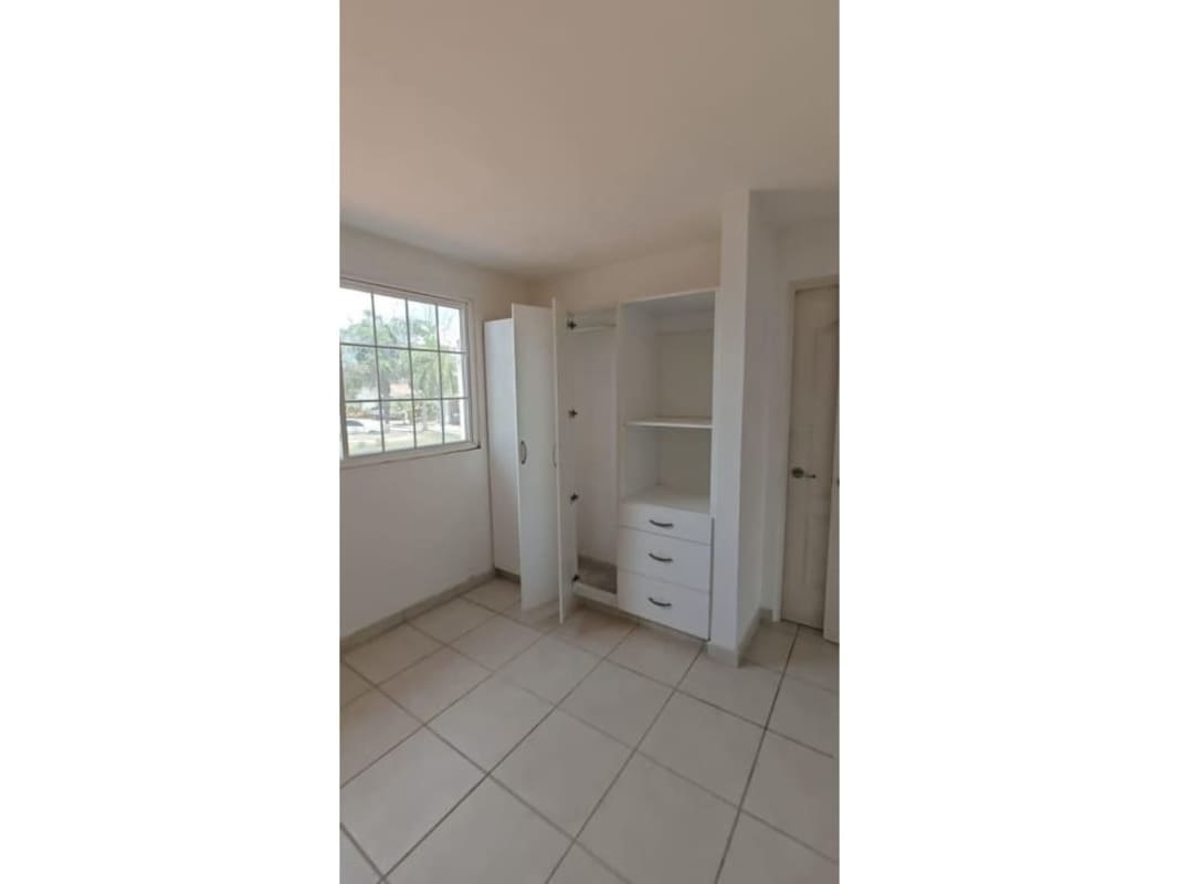 Bright bedroom with built-in wardrobe tile flooring in Brisas del Golf Panama house for sale