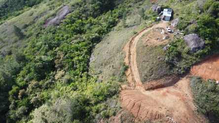 Drone photo mountain slope with clearing dirt road and dense forest Santa Fe Panama