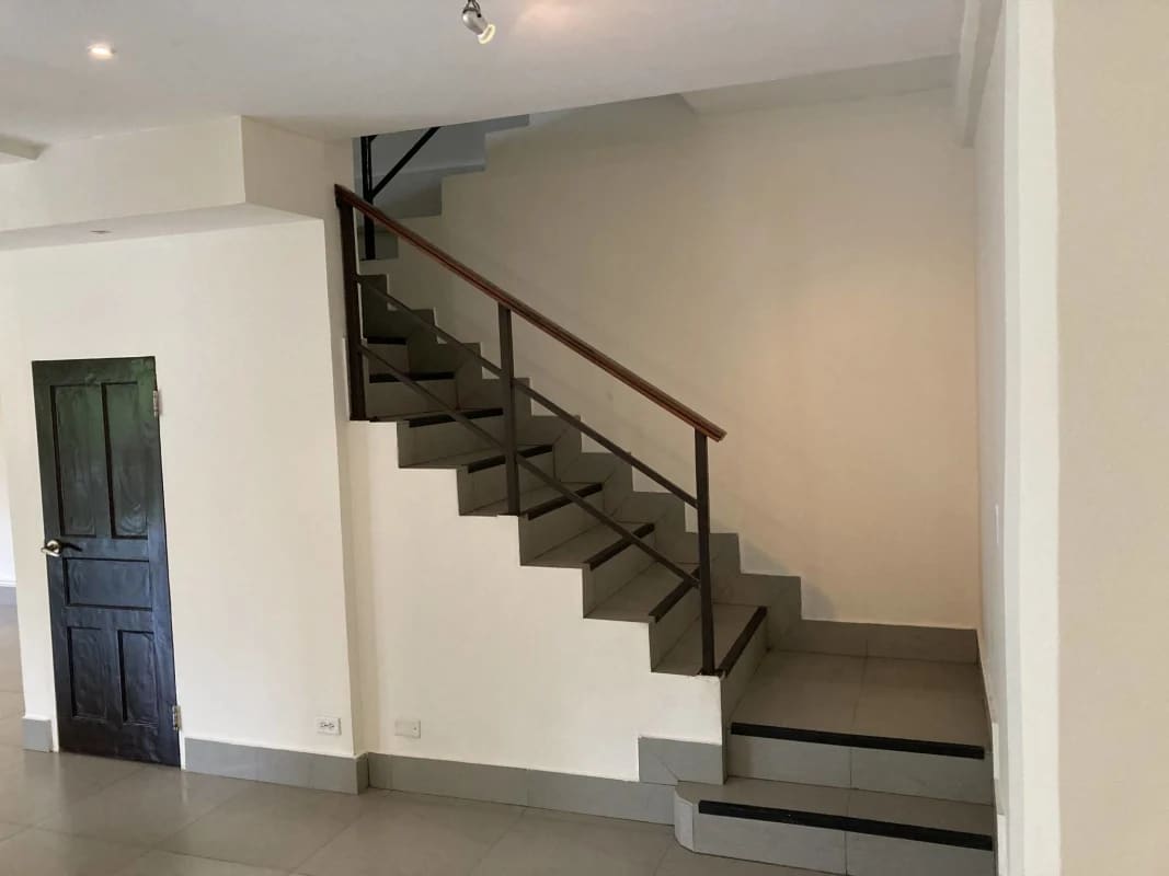 Open indoor staircase with steel and wood railings in luxury home Clayton Panama