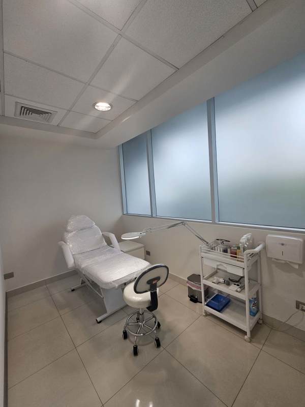 Medical examination room with adjustable chair and frosted windows in Punta Pacífica