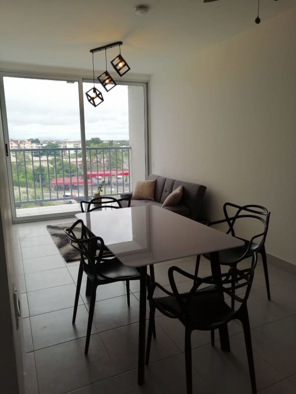 Open space dining and living area with glass door balcony access PH ILO Río Abajo Panama