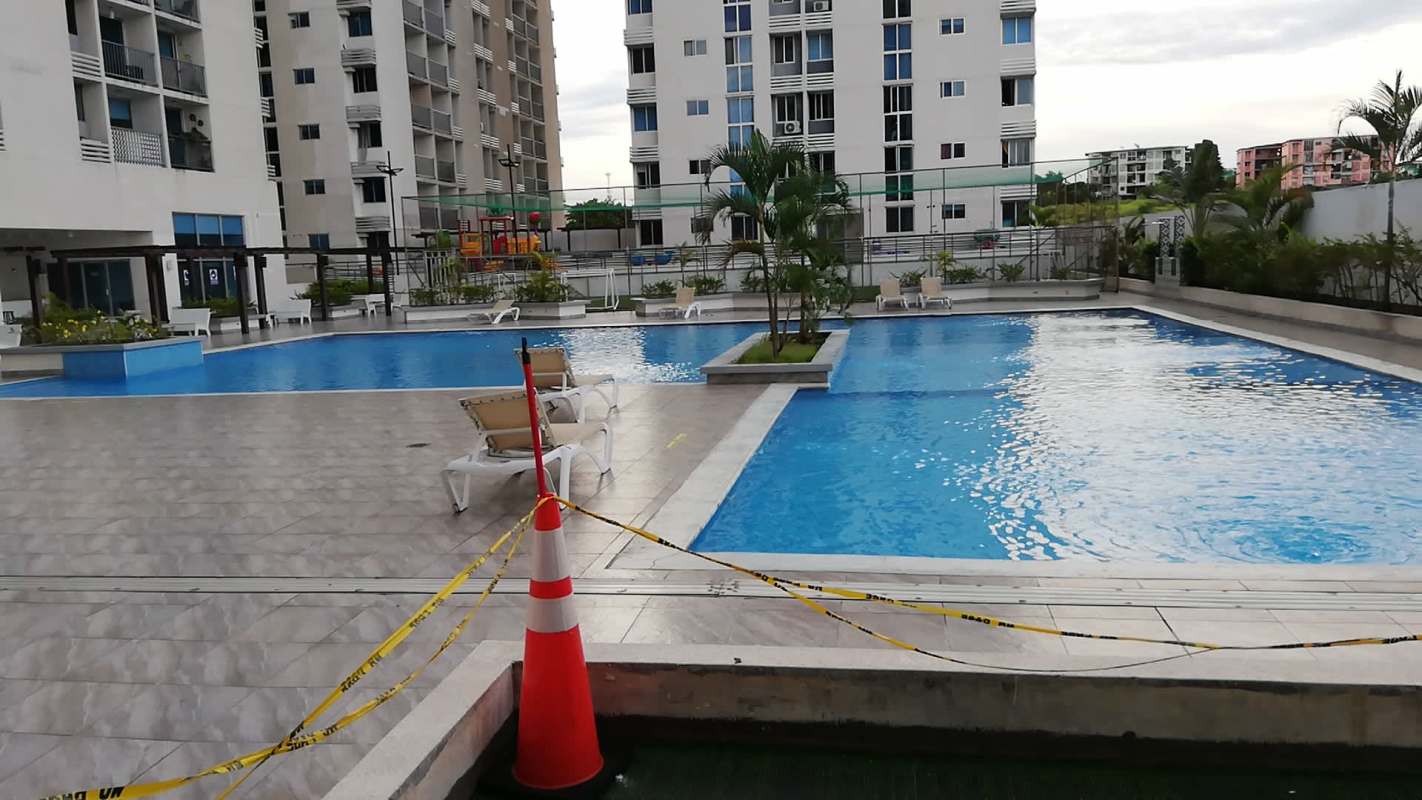 Outdoor swimming pool and social area with lounge chairs at PH ILO Panama City
