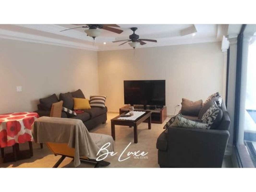 Bedroom with blue walls, wooden closets, dresser and AC unit in Bethania Panama house