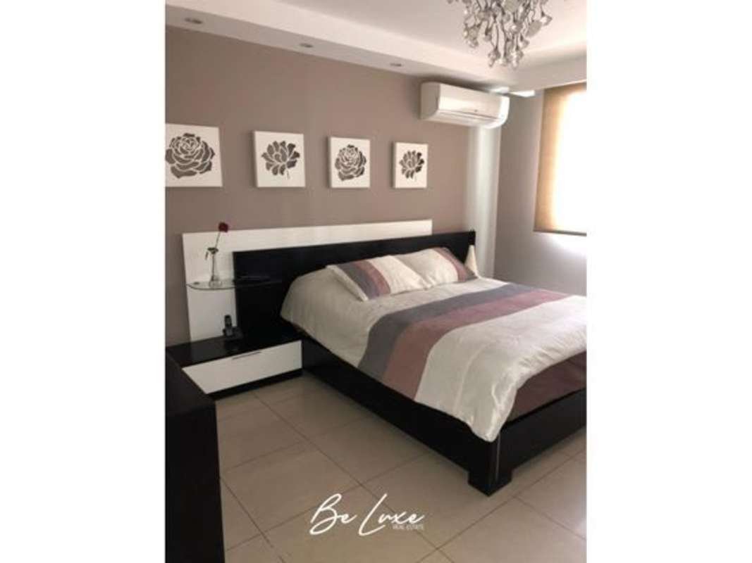 Modern bedroom with large window, Paris-themed decor, and copper pendant lighting in Bethania home