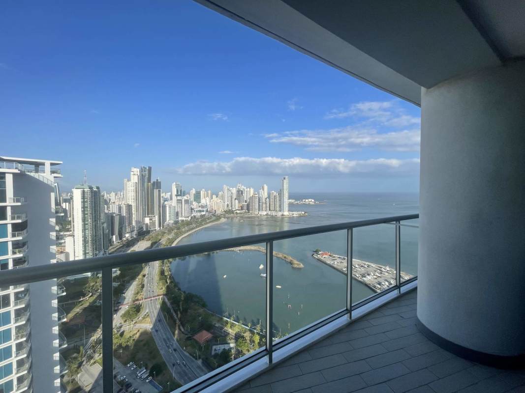 Balcony with glass railing and panoramic ocean and city views Yacht Club Tower Panama