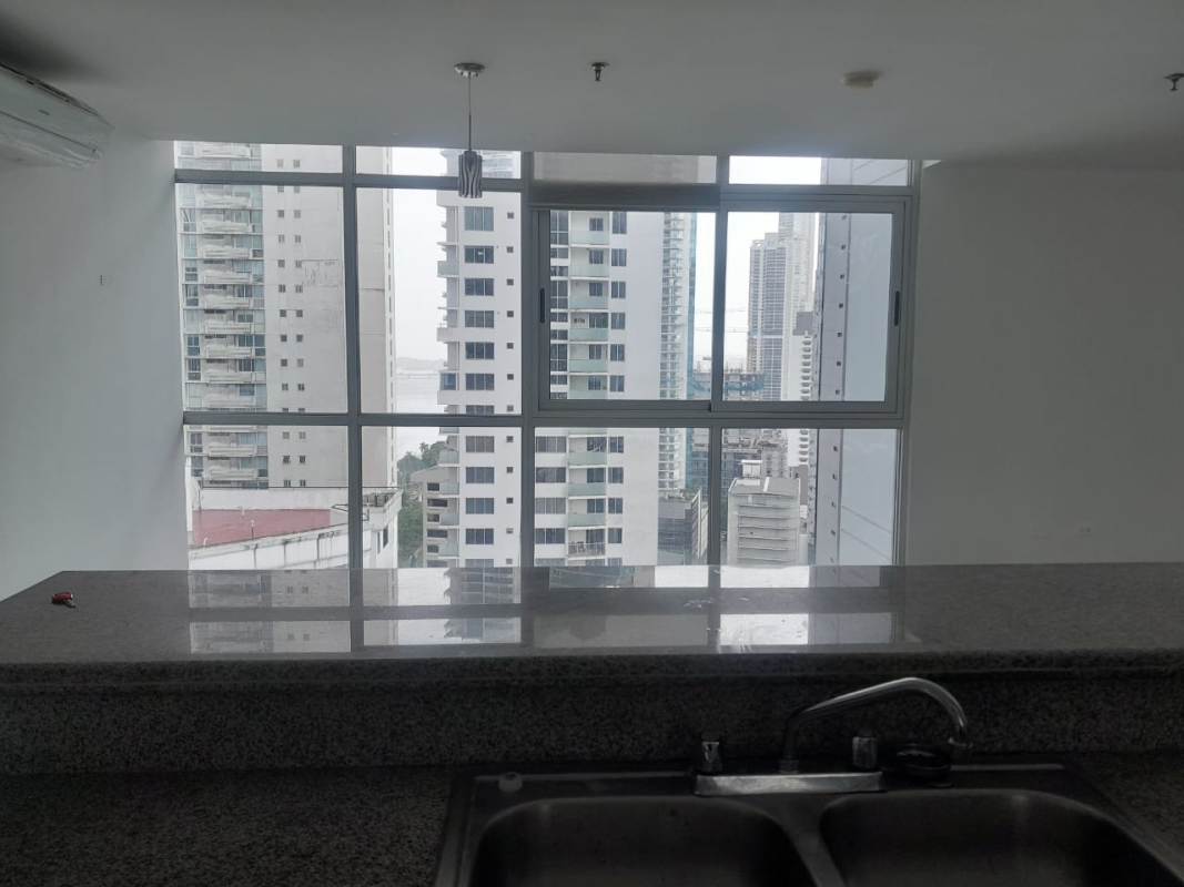 Spacious living room with panoramic ocean and city skyline view at PH Colores de Bella Vista Panama