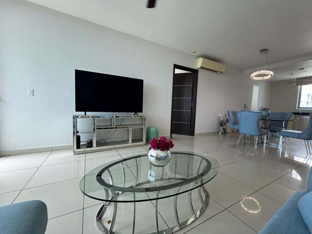 Spacious living room with blue sofa, dining table, modern decor in PH Allure Avenida Balboa