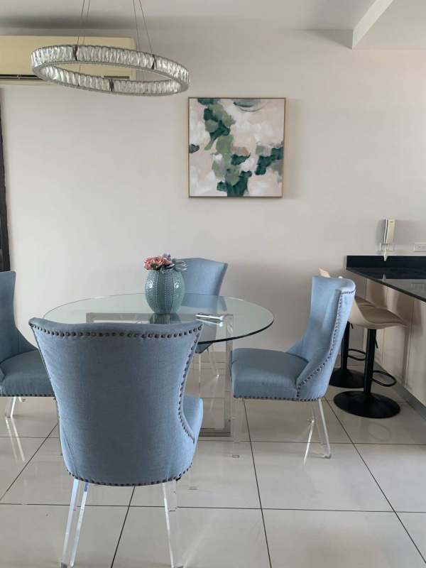 Modern dining area with blue chairs and glass table PH Allure Panama