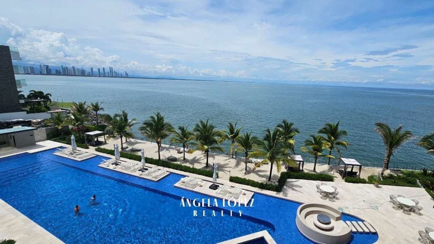 Infinity pool with loungers, umbrellas and ocean view at Seascape Ocean Reef Islands luxury condo Panama