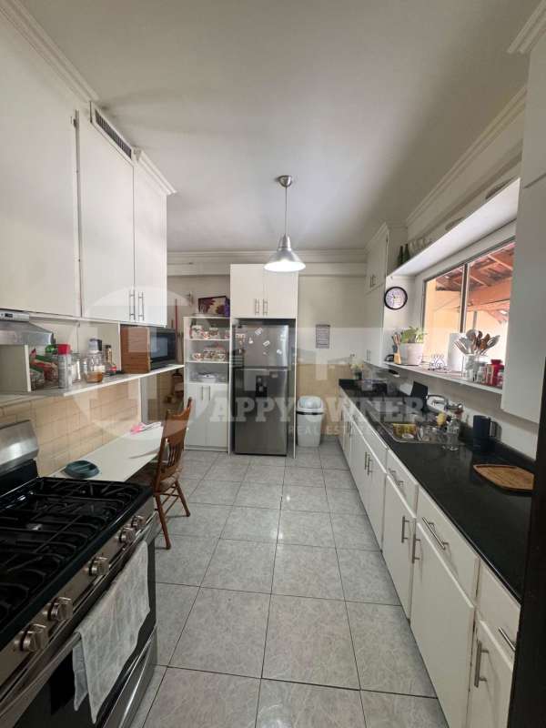 Contemporary kitchen with white cabinets and dark granite counters PH Albrook Park