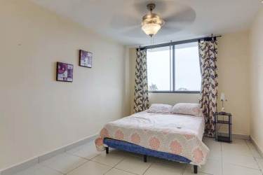 Bedroom opening to balcony in PH El Peñón Playa Blanca beach condo