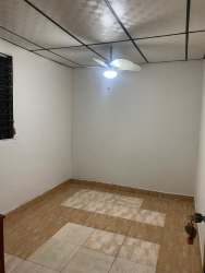 Bedroom interior with tiled floors ceiling fan and window bars in Los Cerezos Vacamonte Panama