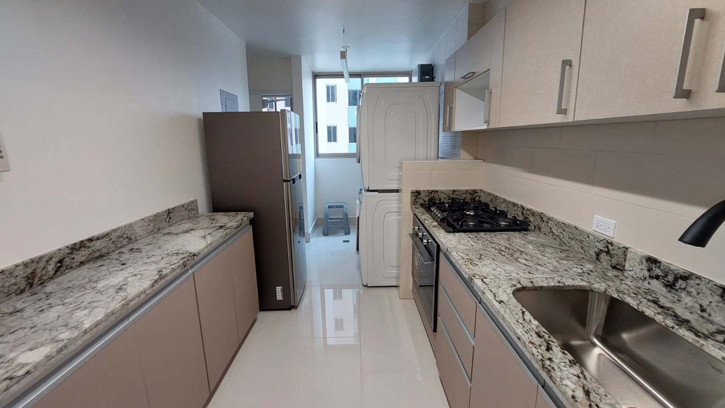 Modern kitchen with granite countertops, built-in oven, gas stove, washer-dryer in PH San Francisco Bay Panama City