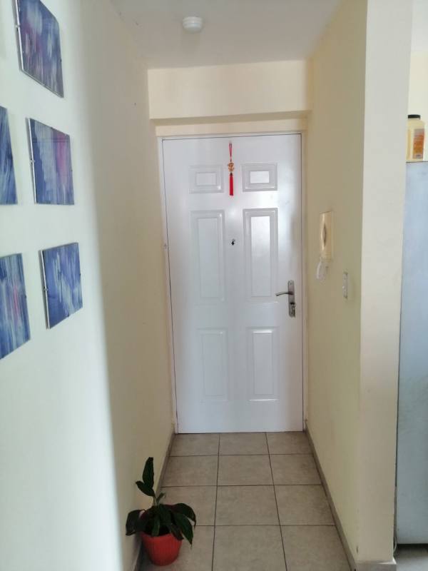 Modern kitchen with gray cabinets, double sink, microwave, gas stove at PH Marquez Panama City