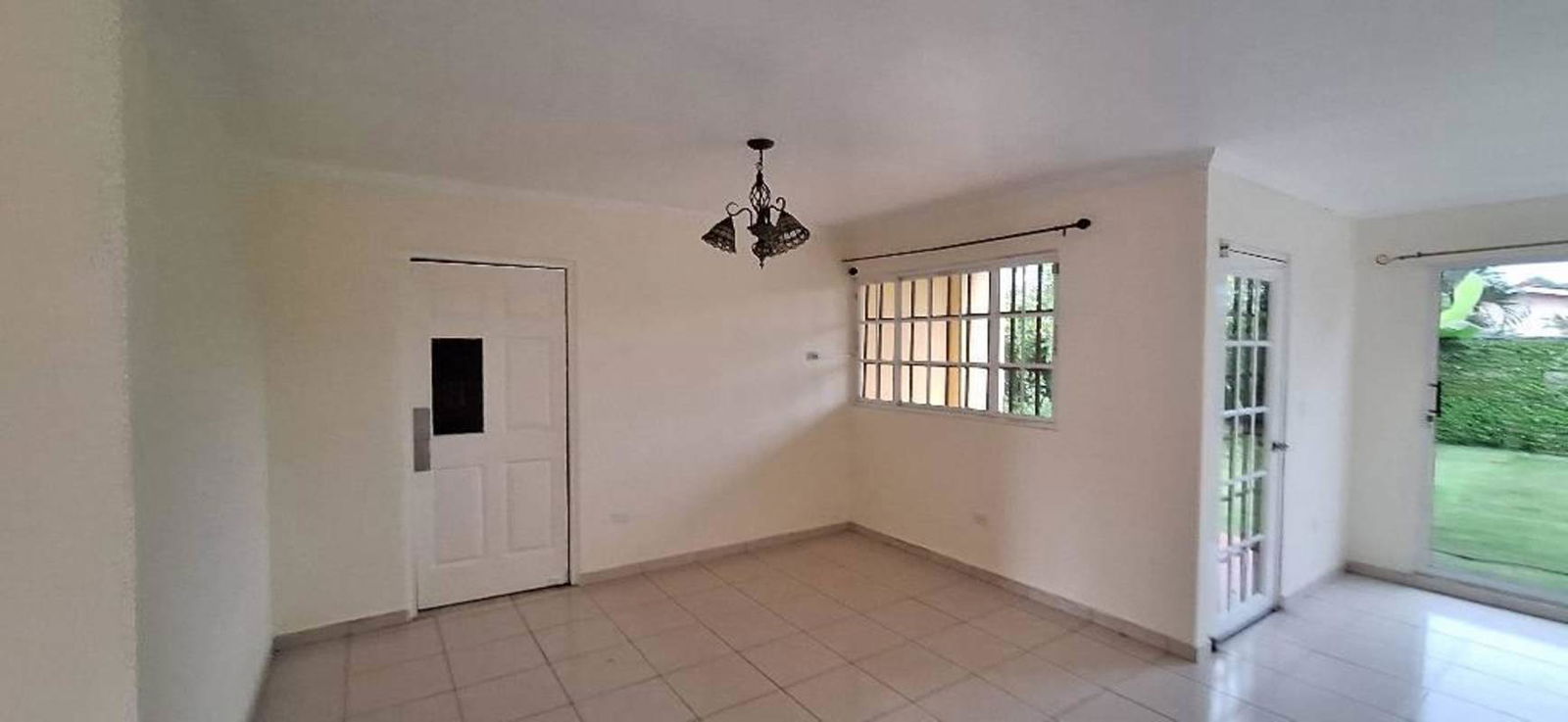 Bedroom with tiled floor, large window and closet space in house for sale Villa Zaita Panama
