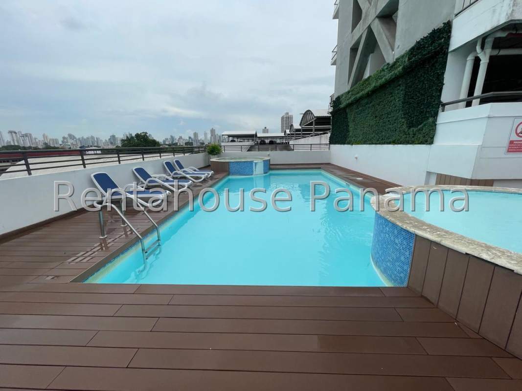 Open living room with large sliding door to balcony, wood flooring and city views PH Lefevre 75 Panama