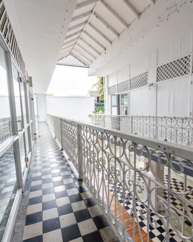 Colonial covered balcony space with ornate iron railings and checkered tile Casco Viejo Panama