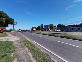 Commercial street with sidewalk, billboards, parking lots near Interamericana in Chame Panama