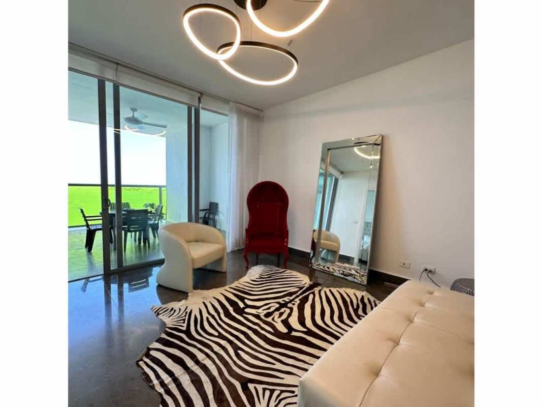 Minimalistic bedroom with tufted bed and floor-to-ceiling window in luxury Panama apartment