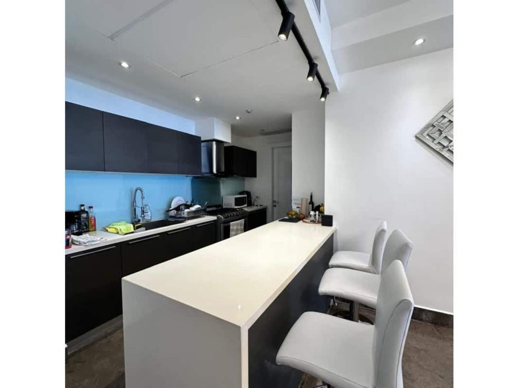 Modern kitchen design with island, stainless appliances in luxury condo Panama City