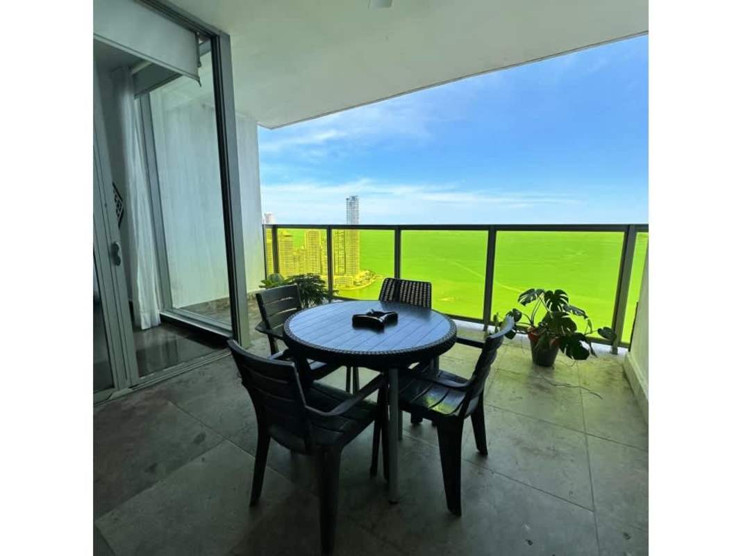 Balcony seating area with panoramic view over Bay of Panama luxury condo