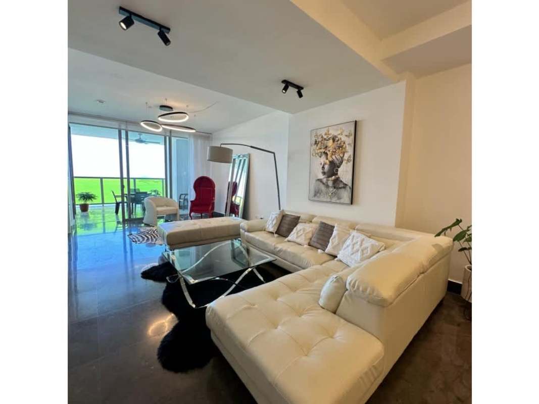 Contemporary living space with large glass doors opening to balcony with ocean view Panama