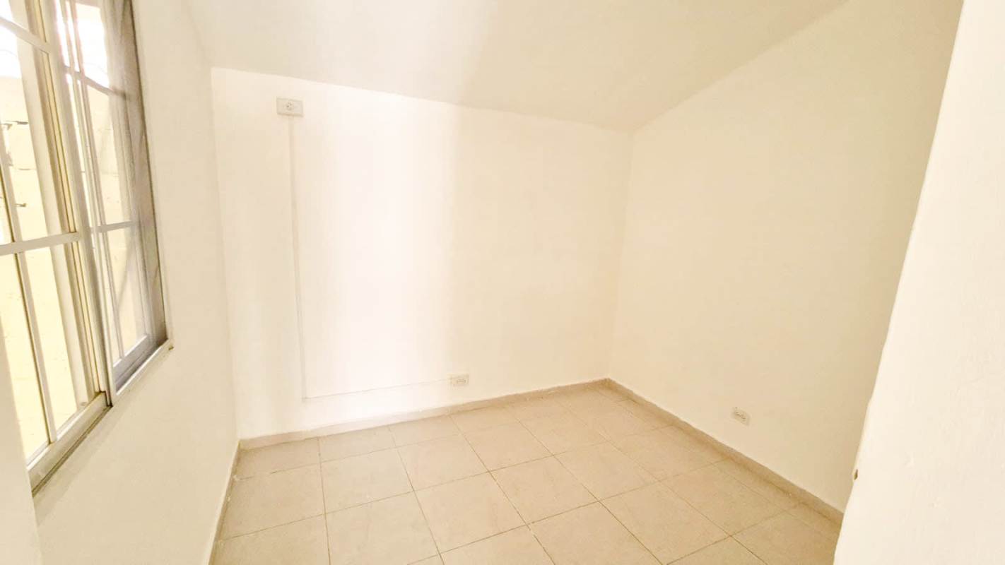 Modern townhouse blue and white balcony front grid windows Villas del Naranjal Pedregal Panama