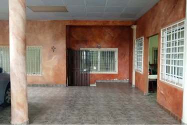 Covered carport with metal gate and tile floor in residential house Villa Dora 2 David Panama