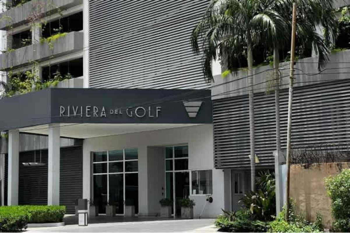 Contemporary minimalist kitchen with island, stainless appliances, white cabinetry at Riviera del Golf Panama City