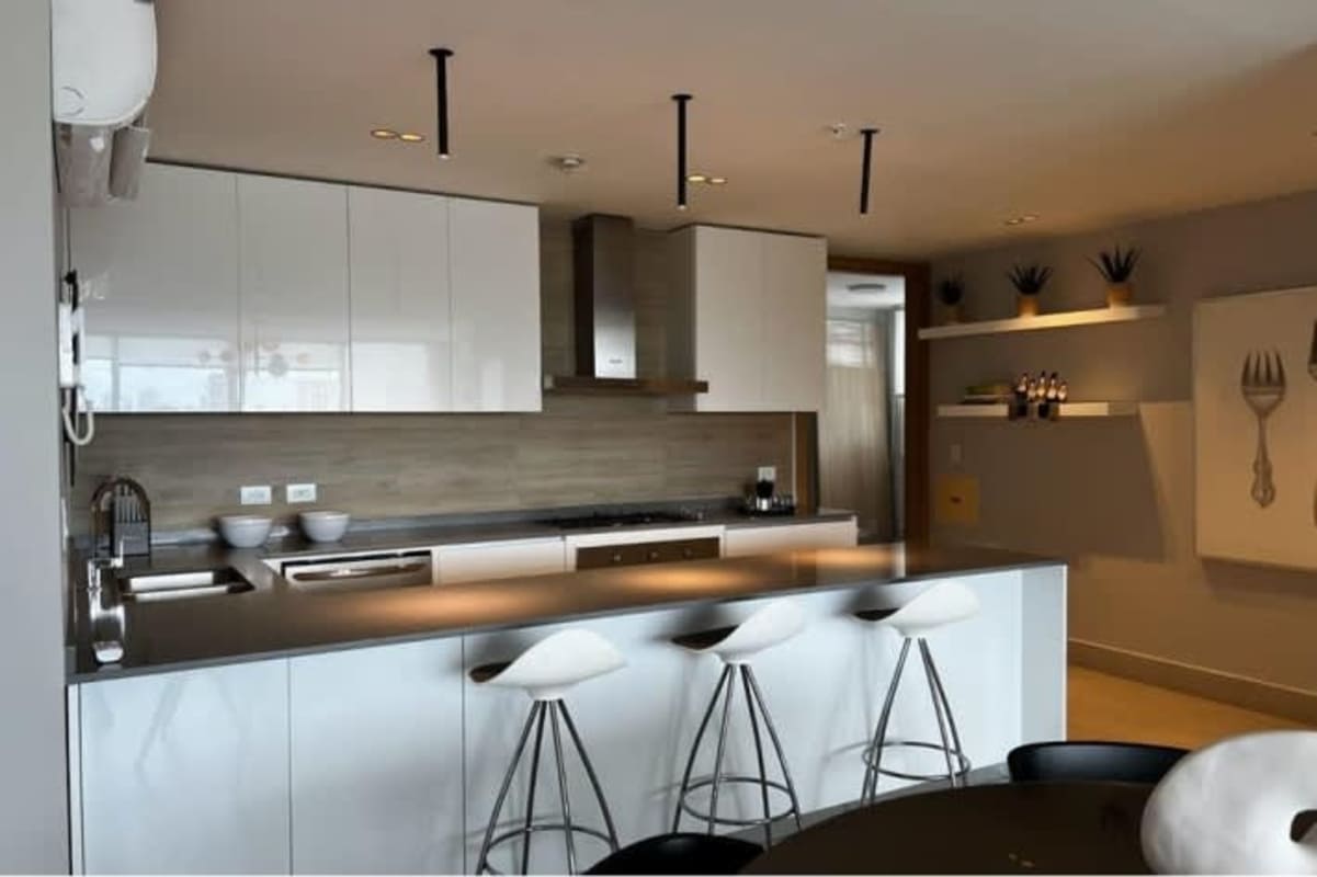 Modern minimalist bedroom with built-in wardrobe, large windows at Riviera del Golf Coco del Mar Panama City