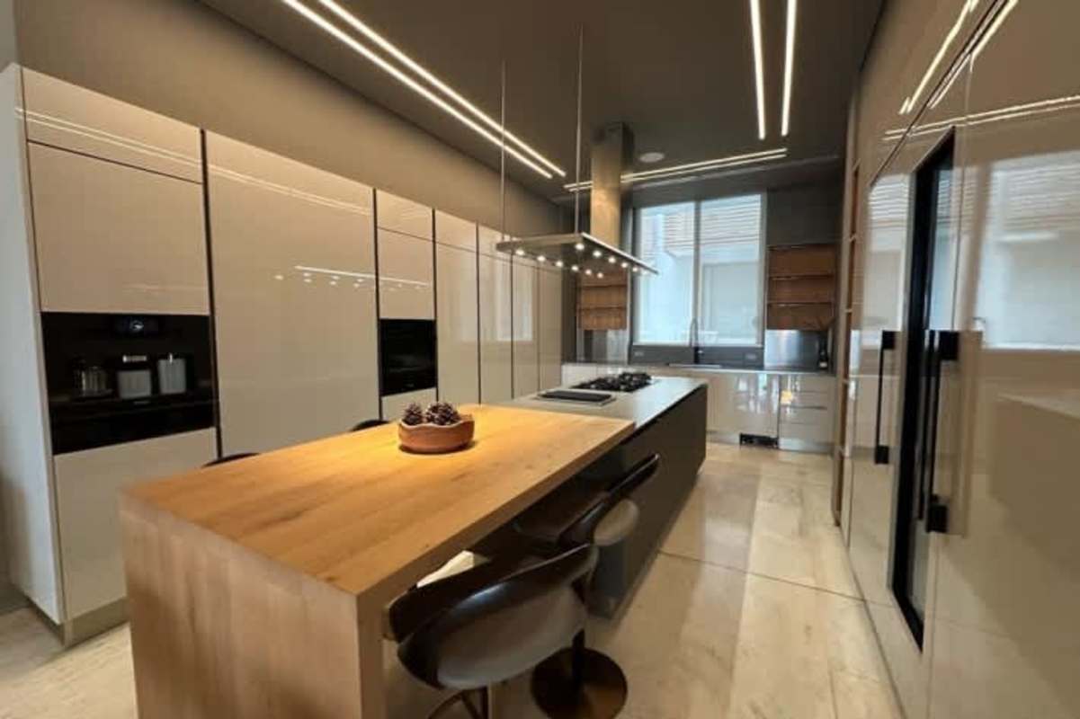 Modern kitchen with island and high-end integrated Miele appliances in Ocean Reef Islands residence Punta Pacifica