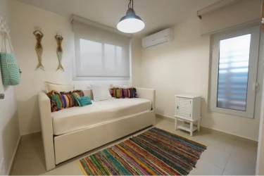 Bright minimalist guest bedroom with daybed large window at Costa Chame Panama beachfront real estate