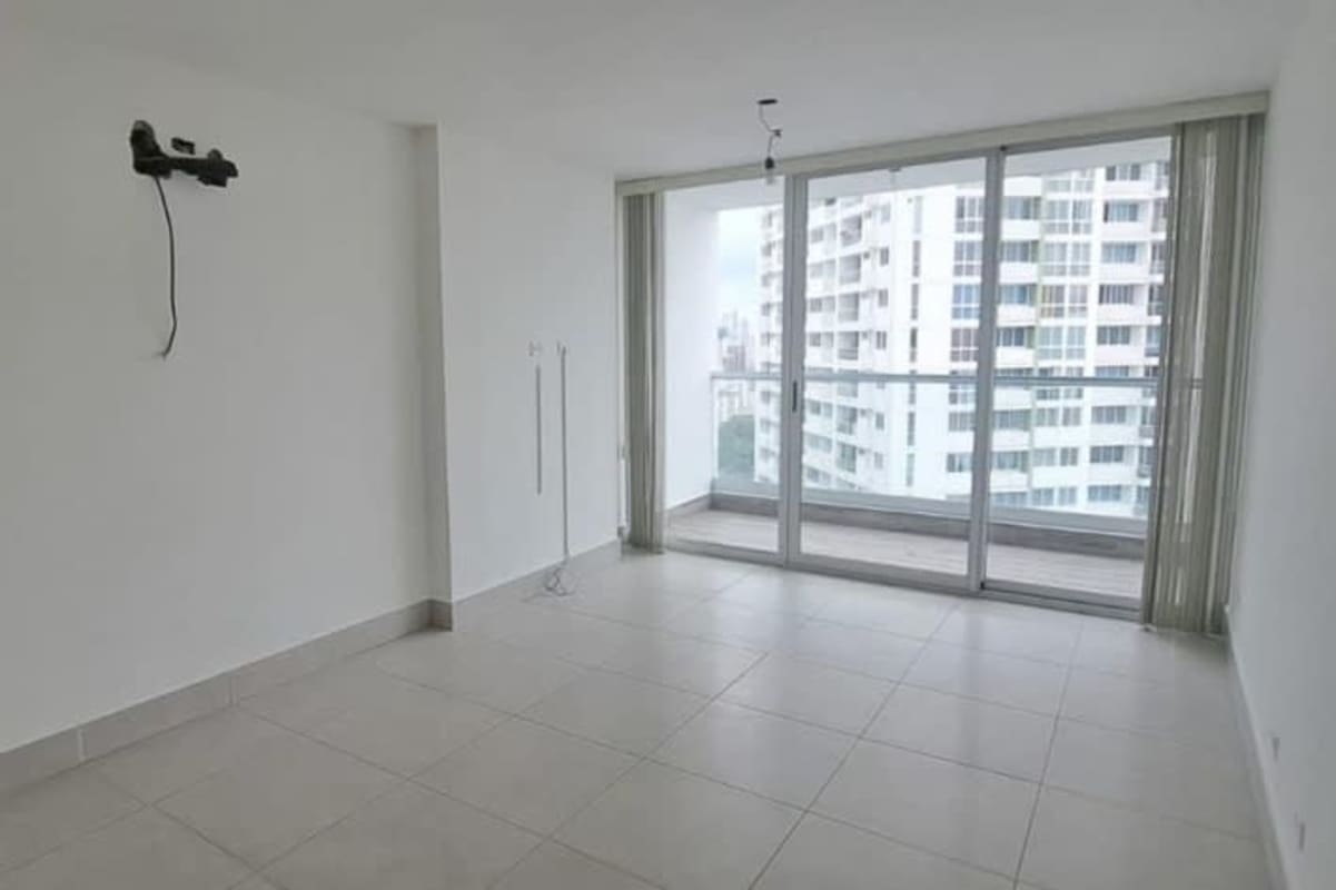 Bright living dining room with sliding glass doors to balcony Edison Park Panama apartment