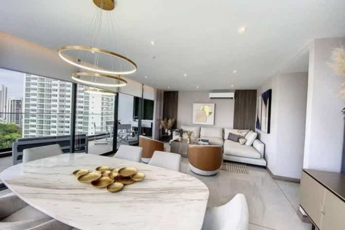 Modern open living and dining with marble table panoramic city ocean views at PH Prestige Bella Vista Panama