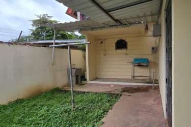 Covered patio with laundry area and small backyard garden in Coronado house for sale