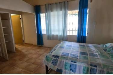 Bedroom with tiled floor, windows and closet in Coronado Beach house Panama