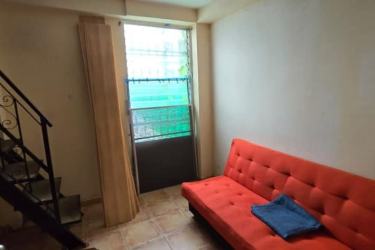 Living room with blue sectional sofa and garden access in Coronado house Panama