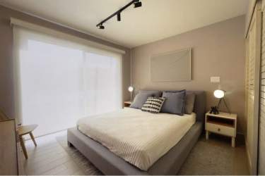 Bedroom with large window and neutral decor in Costa Chame beachfront condo Panama