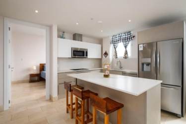 Bright living and dining with access to balcony overlooking marina at Buenaventura Panama