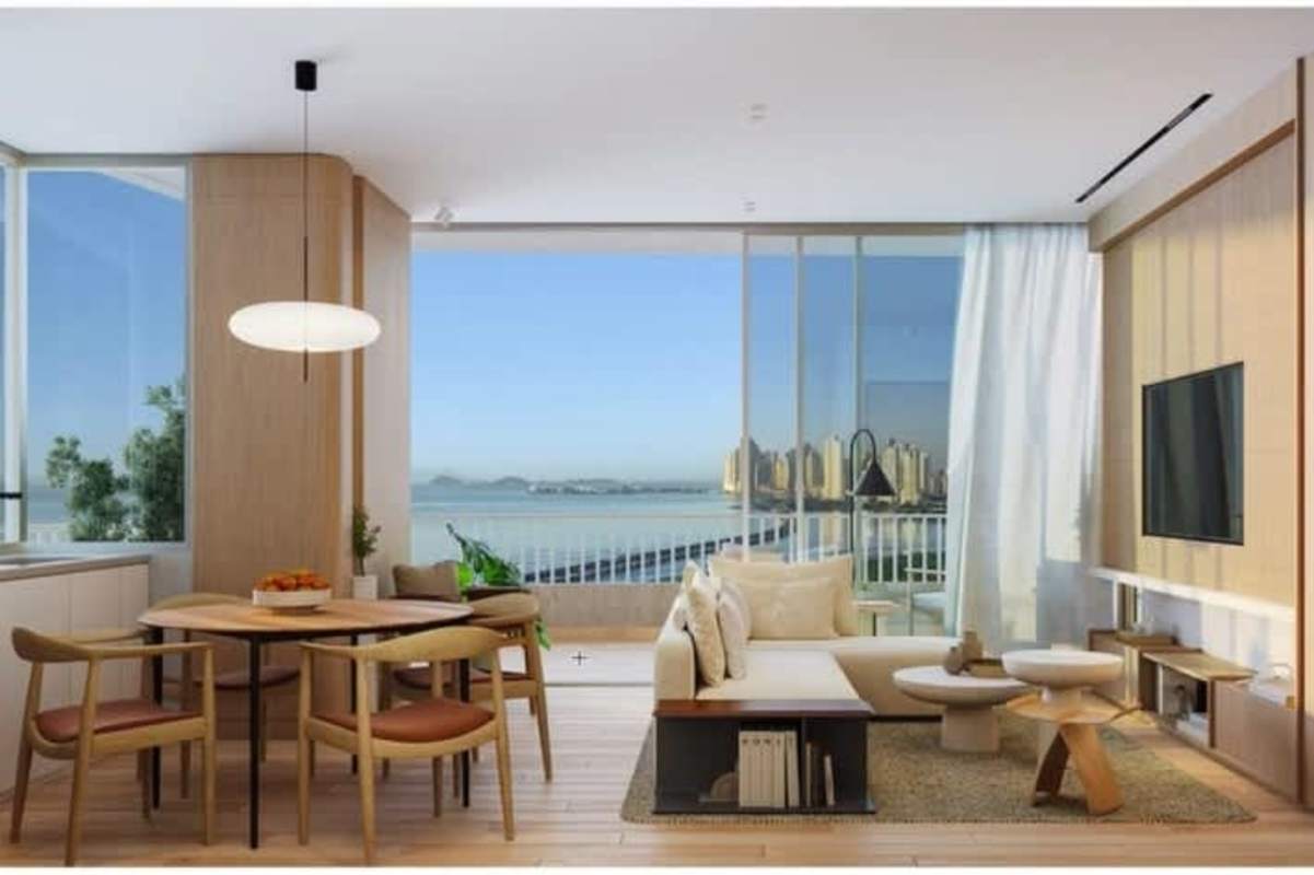 Open living area with ocean views, floor-to-ceiling windows, balcony access in PH Ipanema Panama City