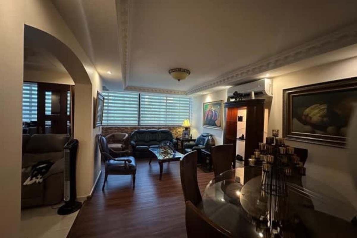 Traditional dining room with decorative moldings, large window, classic furnishings at PH Bahia Azul Panama