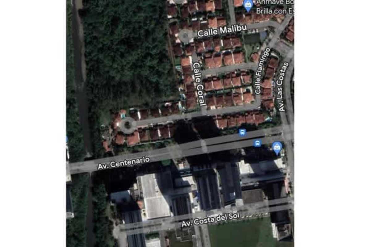 Aerial view over red-tiled roof homes and avenues near land parcel in Costa del Este Panama