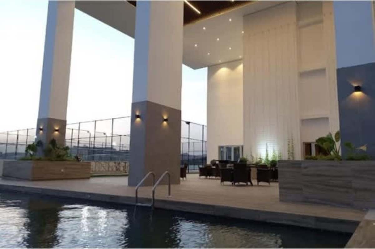 Outdoor pool area with seating high ceiling patio PH Greenwood Towers Panama City