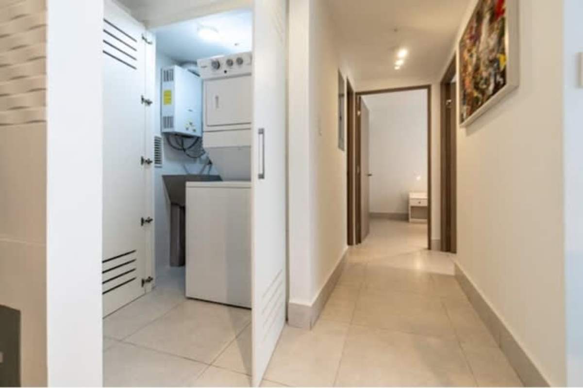 Hallway with stacked washer dryer in condo unit PH Greenwood Towers Panama