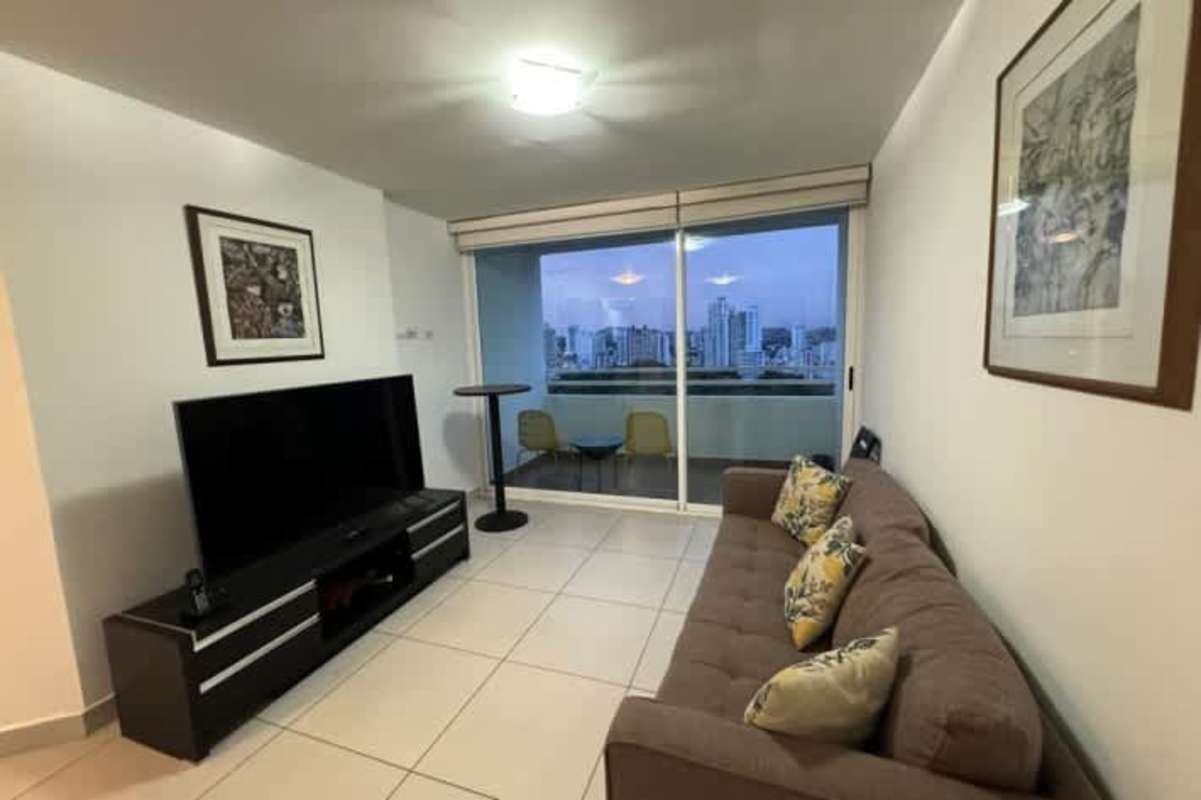 Kitchen with granite countertops, upper and lower cabinets, large refrigerator and gas stove in PH San Francisco Bay Tower