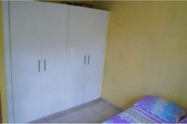 Cozy bedroom in family house La Chorrera Panama Oeste with built-in closet and tiled floor
