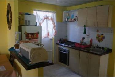 Kitchen interior with microwave oven and cabinets in affordable house Panama