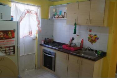 Functional kitchen with gas cooktop, cabinets and window in house for sale La Chorrera